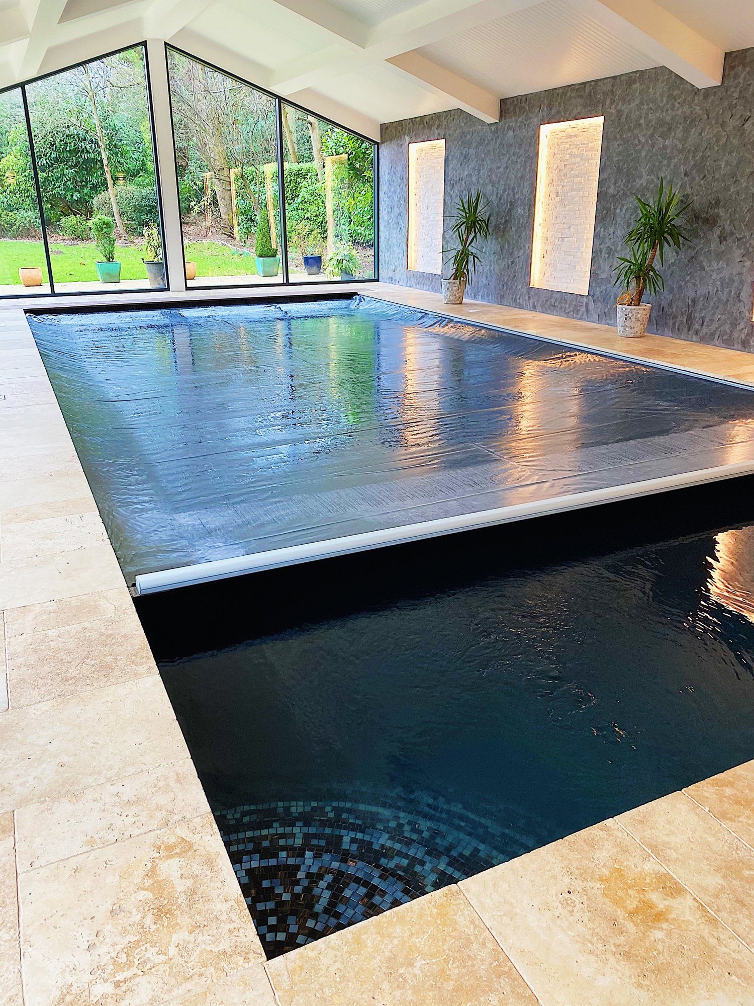 Indoor pool with an automatic safety cover